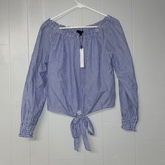 This Striped Blouse Has It’s Original Tag. It Is In Nice Condition. It Is White And Blue Striped. It Is An Off The Shoulder Style And Has A Cute Tie In The Front. Striped Cotton Tops For Brunch, Cotton Striped Tops For Brunch, Off The Shoulder Shirt, Shoulder Shirts, Striped Blouse, Shirt Top, Blue Stripes, White Stripe, Off The Shoulder