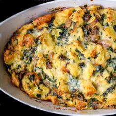 a casserole dish with cheese and spinach