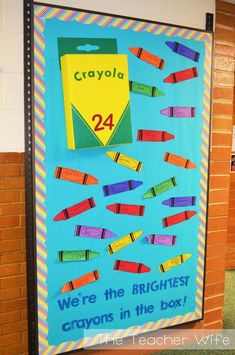 a bulletin board with crayons on it and the words crayola written in blue