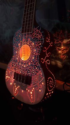 a lit up guitar sitting on top of a table