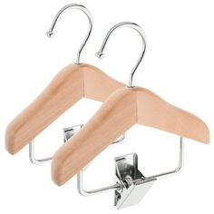 two wooden clothes hangers with metal clips