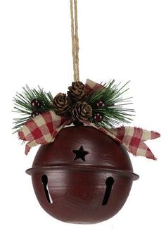 a christmas ornament hanging from a rope with pine cones and evergreens on top