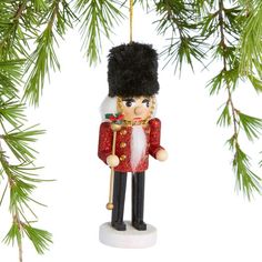 a nutcracker ornament hanging from a tree