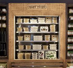 a display case in a store filled with lots of plates and containers on shelves next to each other