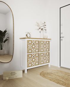 a room with a mirror, dresser and rug on the floor in front of it