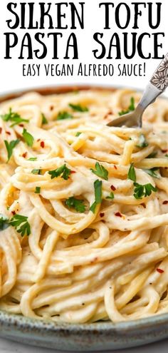 a close up of a plate of pasta with sauce and parsley on the side