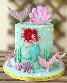 the little mermaid cake is decorated with fondant