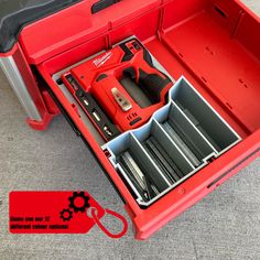 a red toolbox with tools in it on the floor