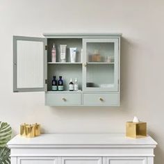 a white cabinet with some bottles on top of it