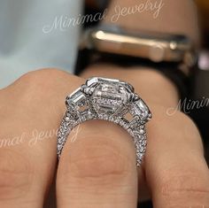 a woman's hand holding an engagement ring