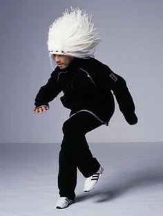 a young man with white hair is dancing