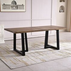 a wooden table sitting on top of a white rug