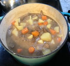 a pot filled with stew sitting on top of a stove