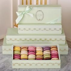 three boxes with different colored macaroons in them