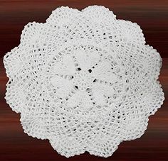 a white doily on top of a wooden table with the words 6 pcs written below it