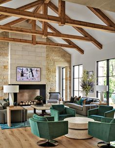 a living room filled with furniture and a fire place in the middle of a room