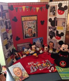 mickey mouses and other items are on the table in front of a red wall