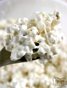 a spoon full of popcorn is being held up