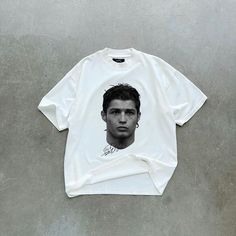 Classic Iconic Football Legend T-Shirt - Limited Edition Show off your passion for football with this bold, minimalist white t-shirt featuring a stunning portrait of one of the game's greatest of all time (GOAT). Designed for fans who admire both style and the unstoppable spirit of football greatness, this tee is perfect for everyday wear--whether you're hitting the gym, watching a match, or just hanging out. Premium quality: Soft, breathable cotton blend for ultimate comfort. Striking design: M Ronaldo T Shirt, C Ronaldo, Monochrome Portrait, Greatest Of All Time, Minimalist White, White Tshirt, Effortless Style, Jogging, Timeless Fashion