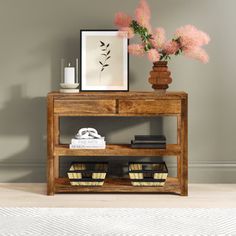 a wooden shelf with flowers and books on it next to a white rug in a room