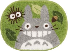 a rug with an image of a totoro and some plants on it's side