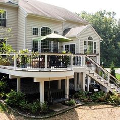 a large white house with a deck and patio