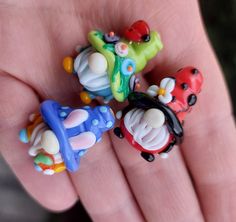 three small toy cars sitting on top of someone's hand in the palm of their hand