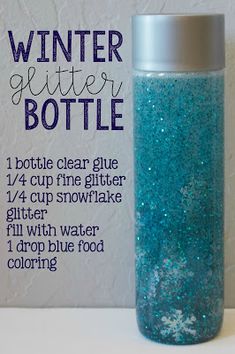 a bottle filled with blue glitter sitting on top of a white table next to a sign