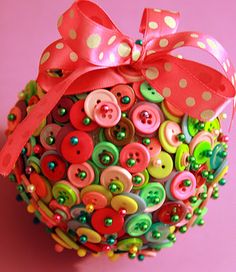 a close up of a ball with buttons on it and a bow around the top