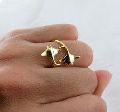 The Twin Manta Ray Ring, made from 925 sterling silver and finished with a 14k Hamilton gold plating. This unique ring features a wrap-around bypass design inspired by the graceful movement of manta rays of the coast of Hawaiian islands, available in a sleek silver color. Also Available in Silver Color: Silver: Ceramic Manta Ray, Manta Ray Jewelry, Stingray Jewelry, Adjustable Silver Ocean-inspired Rings, Swim With Manta Rays, Bypass Ring, Manta Ray, Eternity Band Ring, Opal Rings