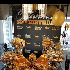 a table topped with lots of desserts and balloons