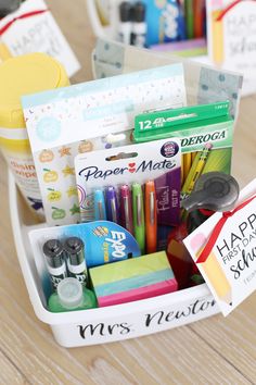 a basket filled with school supplies on top of a wooden table