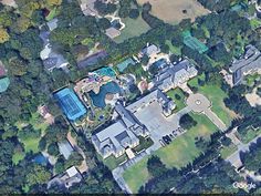 an aerial view of a large house surrounded by trees