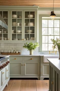 a kitchen filled with lots of counter top space next to a stove top oven and sink