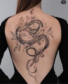 the back of a woman's body with tattoos on it