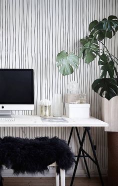 a white desk with a computer on it and a black bench in front of it