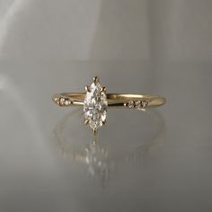 a yellow gold engagement ring with an oval cut diamond