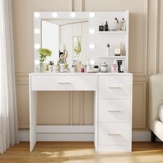 a white vanity with lights on it in front of a mirror and chair next to a window