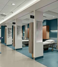 an empty hospital room with blue and white walls