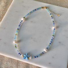 Under The Sea Freshwater Pearl Necklace | Summer Necklace | Beach Jewelry | Beaded Necklace | Coconut Girl Aesthetic | Seed Bead Jewelry by myearthyaura on Etsy Cheap Blue Necklaces For The Beach, Cheap Beach Jewelry With Heart Beads, Cheap Dangling Beads Necklace For Beach, Cheap Glass Beaded Necklaces For Beach, Cheap Beaded Beachy Necklaces For Beach Season, Cheap Beaded Chain Necklaces For Beach, Cheap Beaded Strand Necklace For Beach, Minimalist Beaded Necklace For Beach, Cheap Blue Necklaces For Beach