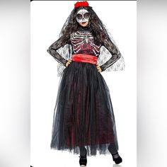 a woman dressed in a skeleton costume and red headband, standing with her hands on her hips