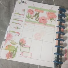 an open planner book with flowers on it