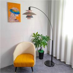 a yellow chair sitting in front of a lamp next to a potted plant