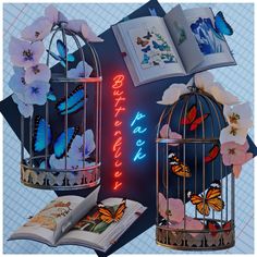 an open book sitting on top of a table next to a birdcage filled with butterflies