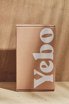 a box with the word yes on it sitting on a table next to a wall