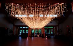 a large room with lights hanging from the ceiling