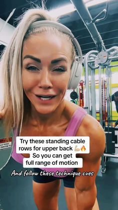 a woman with headphones on in a gym