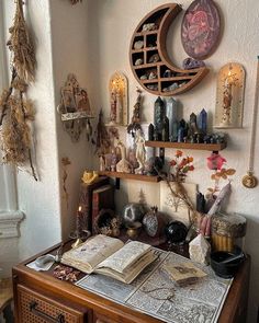 a desk with many items on it and a clock hanging above the top, along with other decorations