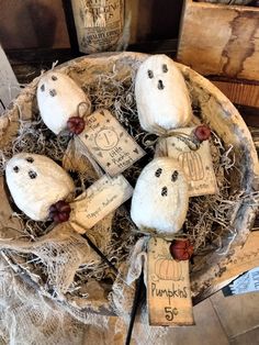 some stuffed animals are sitting in a basket with tags attached to the heads and ears