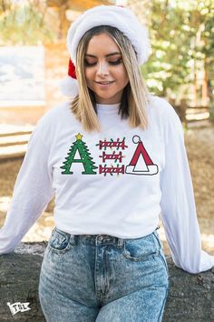 a woman wearing a christmas sweater and santa hat